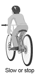 Properly signaling that you're slowing down or stopping on a bicycle.